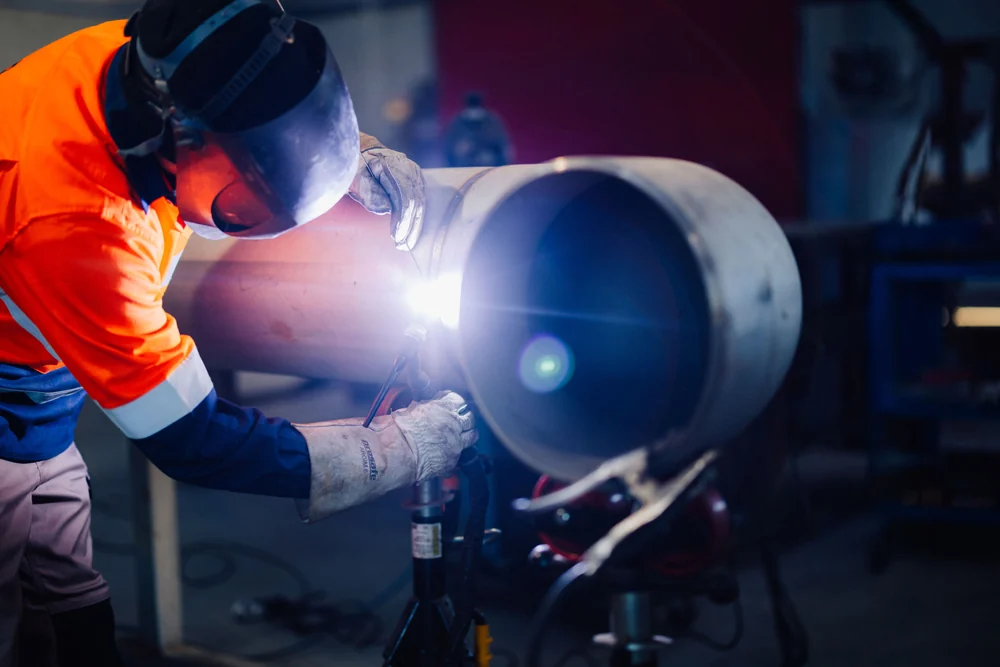 Welder working on a cylindrical steel component in Rolleston